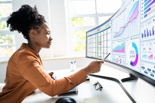 Analyst woman looking at business data analytics dashboard